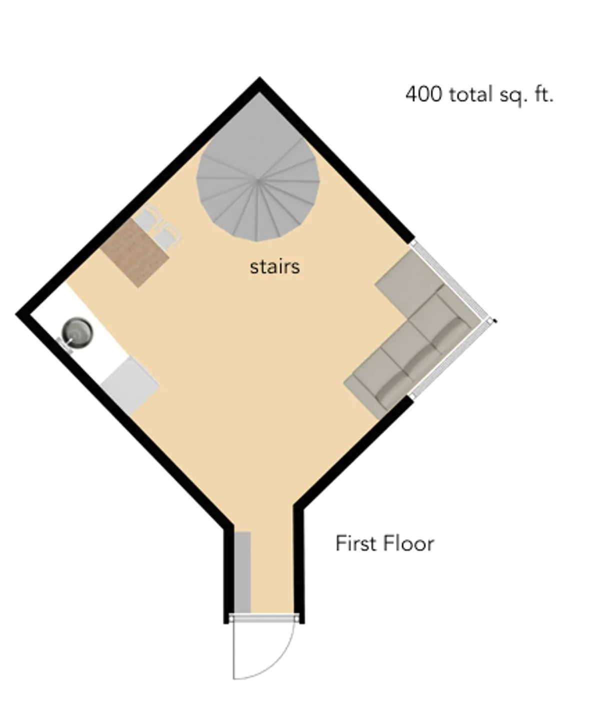 This photo provides a wider view of the open-plan living space, including the stairs, a cozy seating area, and the kitchenette in the background. The setup emphasizes communal gatherings, cooking, and relaxed moments all in one harmonious space.
